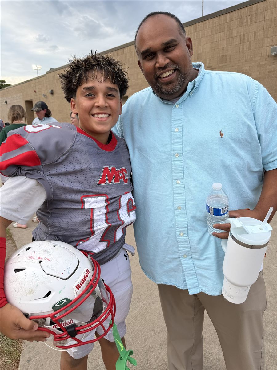 Jason Karamath with his son after a football game